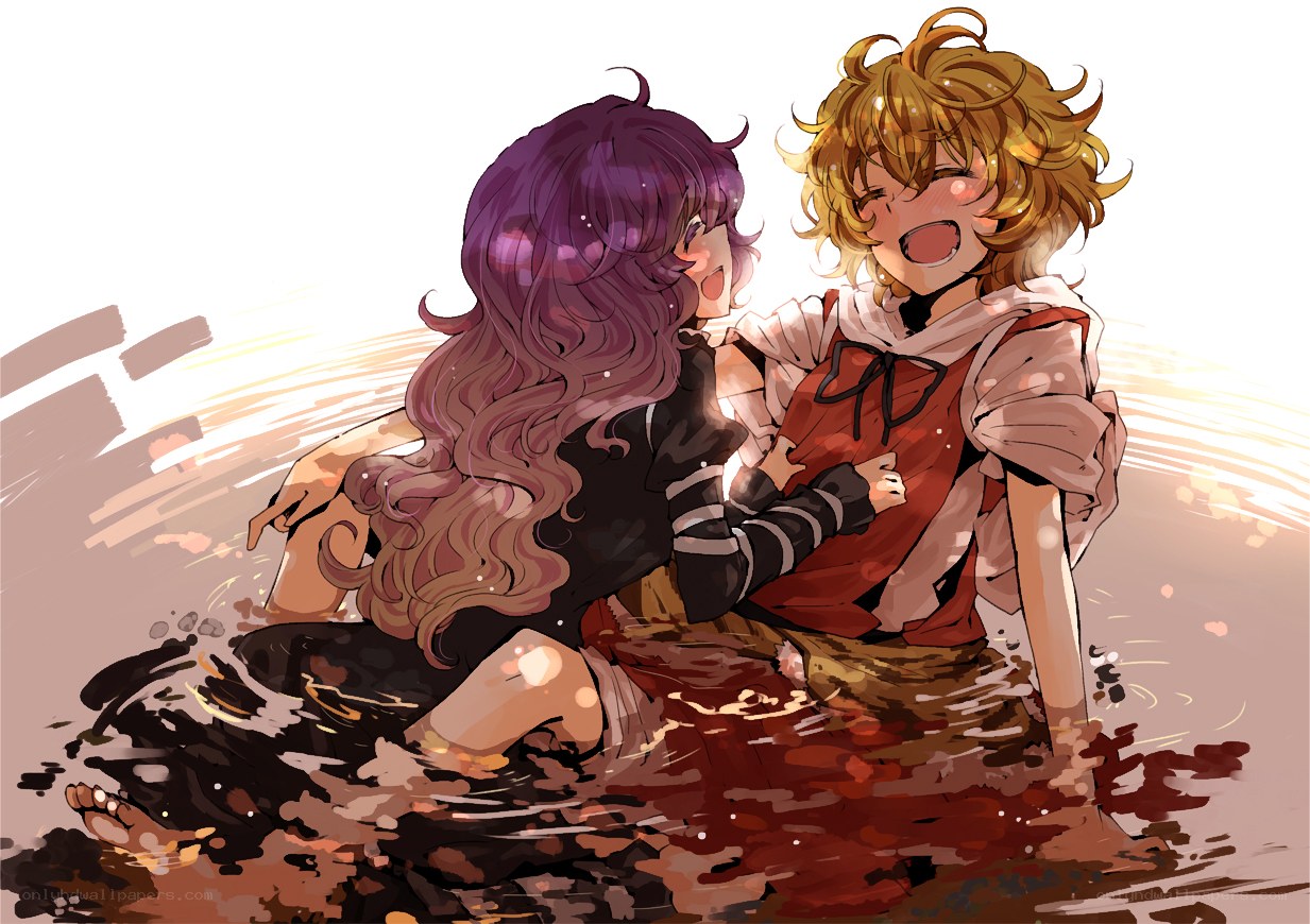 Two girls in a muddy puddle