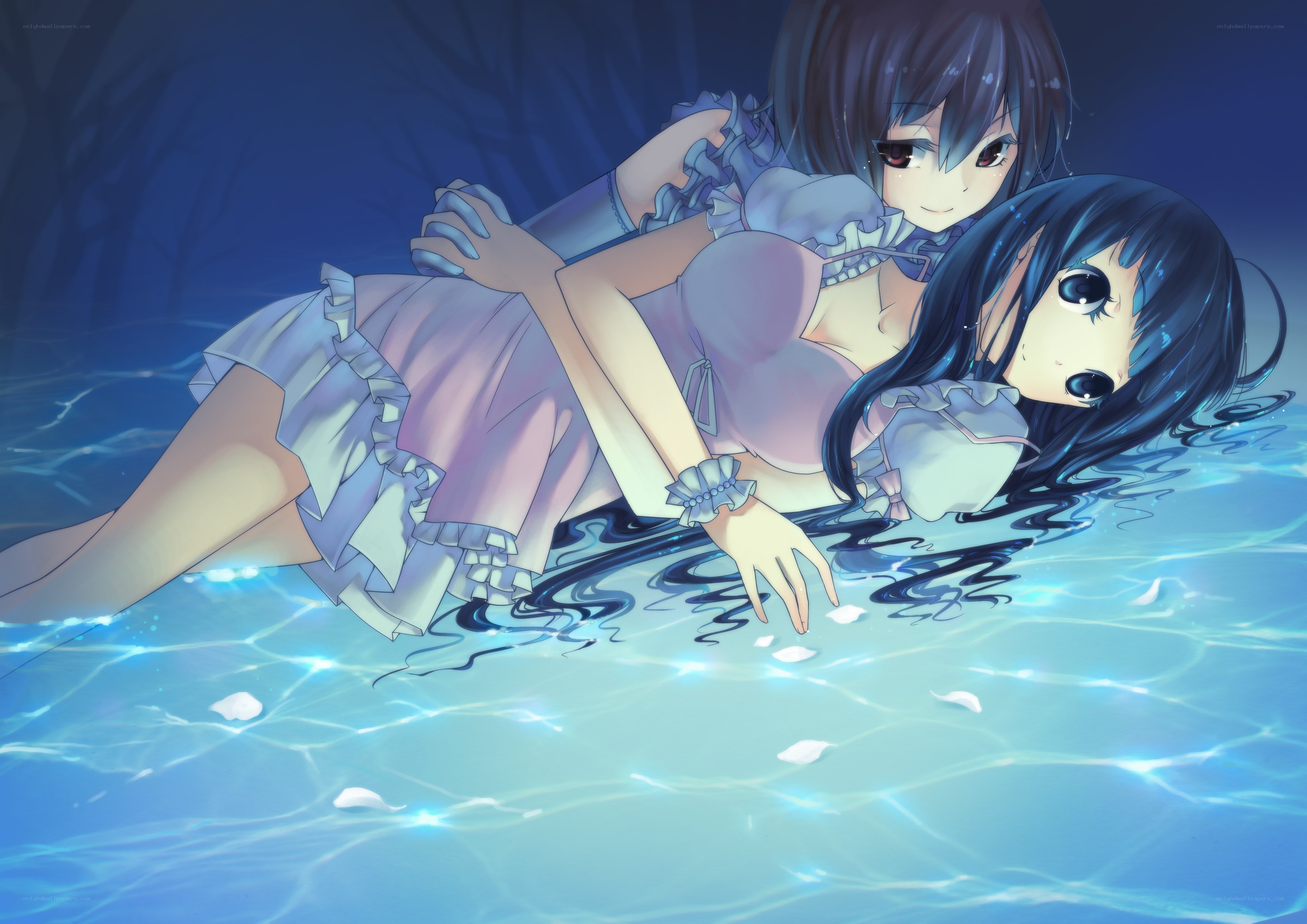 Two girls in a pool at night