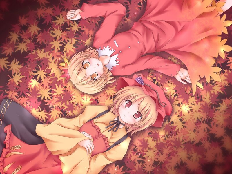 Two girls in autumn leaves