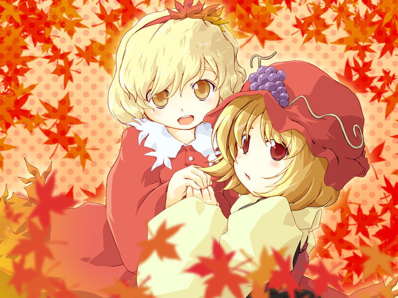 Two girls in autumn leaves