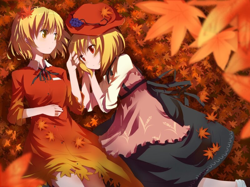 Two girls in autumn leaves