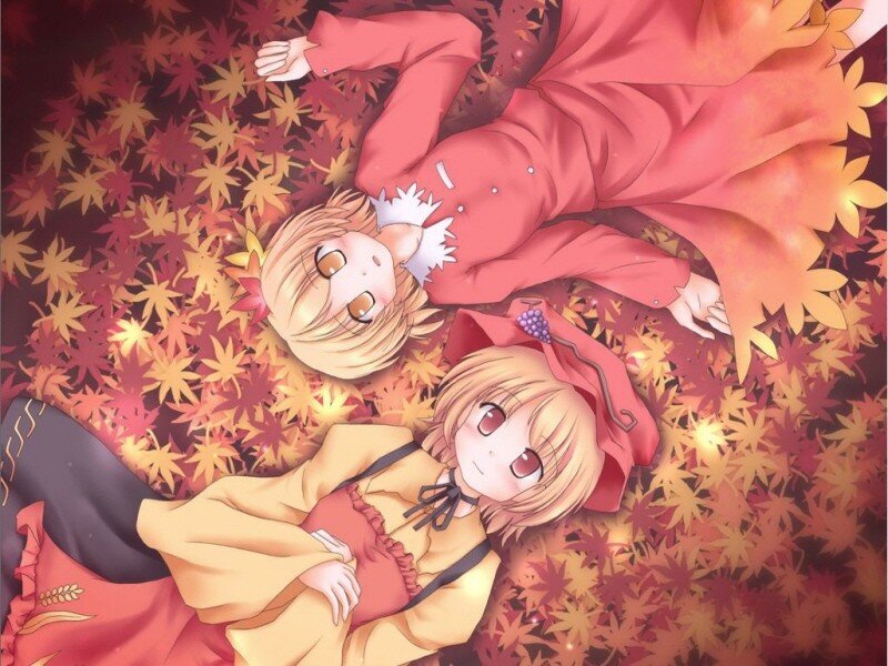 two girls in autumn leaves