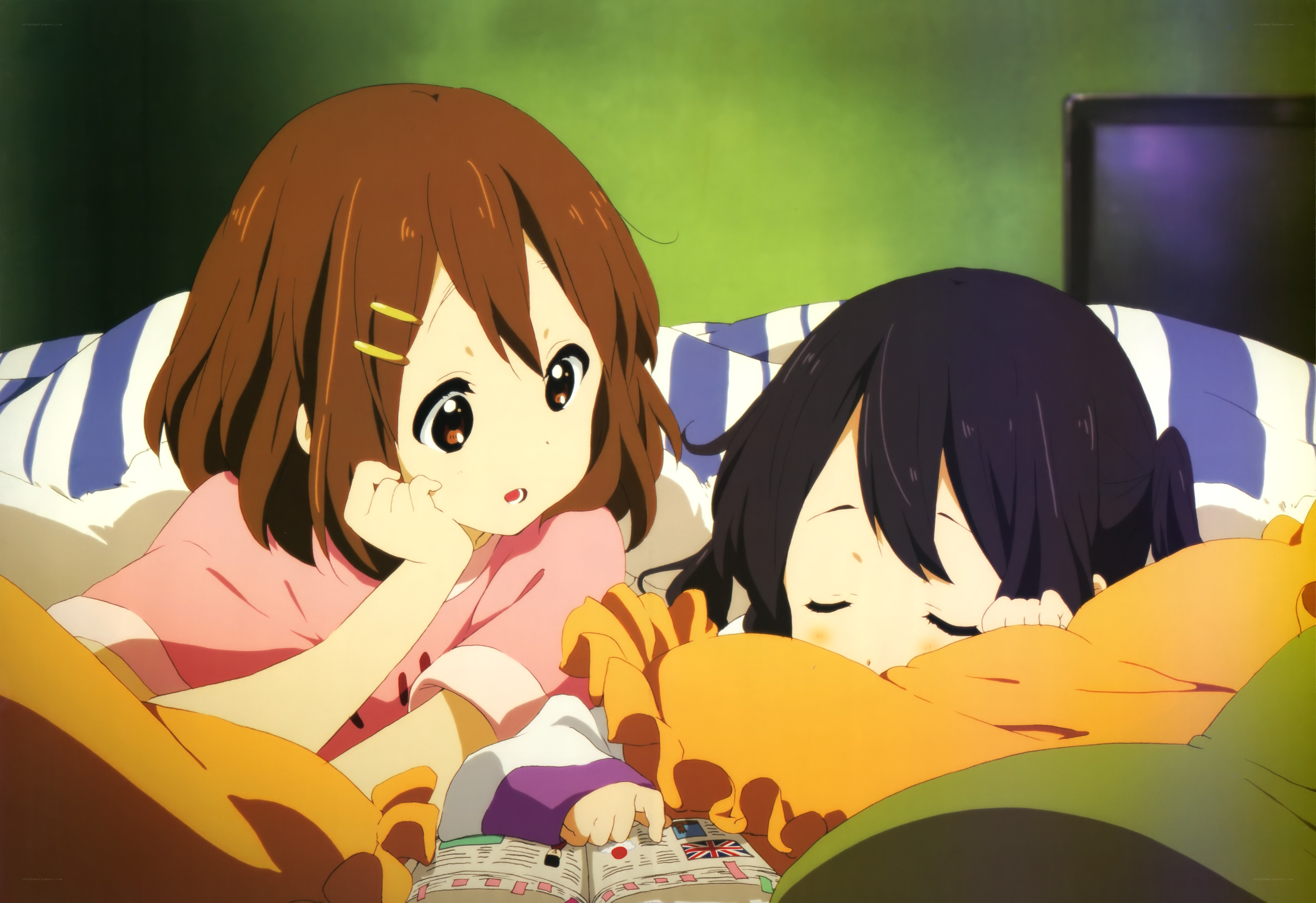 Two girls in bed reading