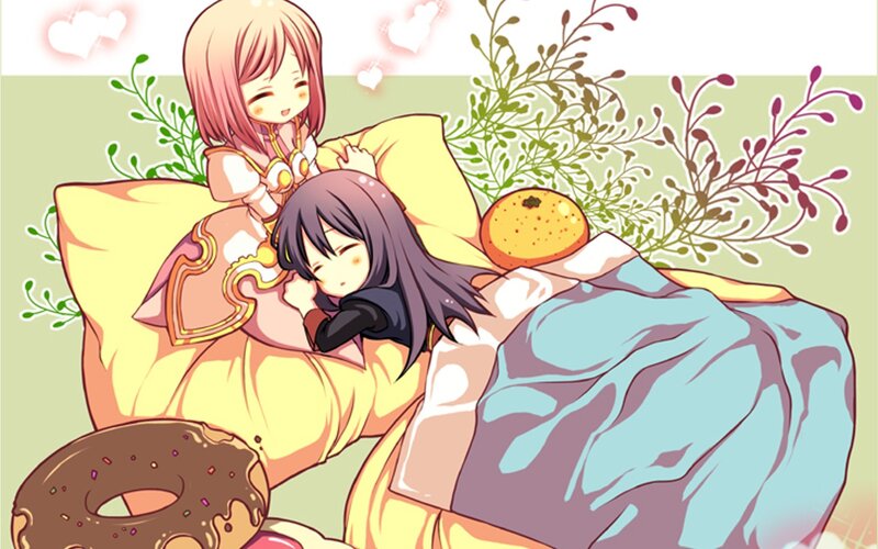 Two girls in bed with donuts