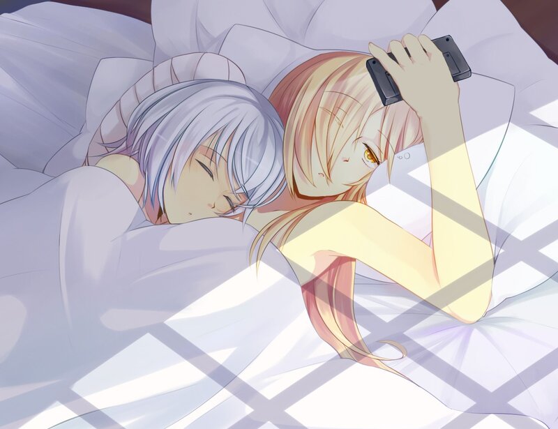 Two girls in bed with phone