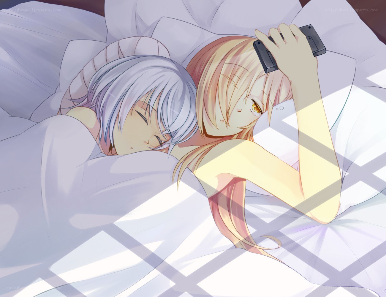 Two girls in bed with phone