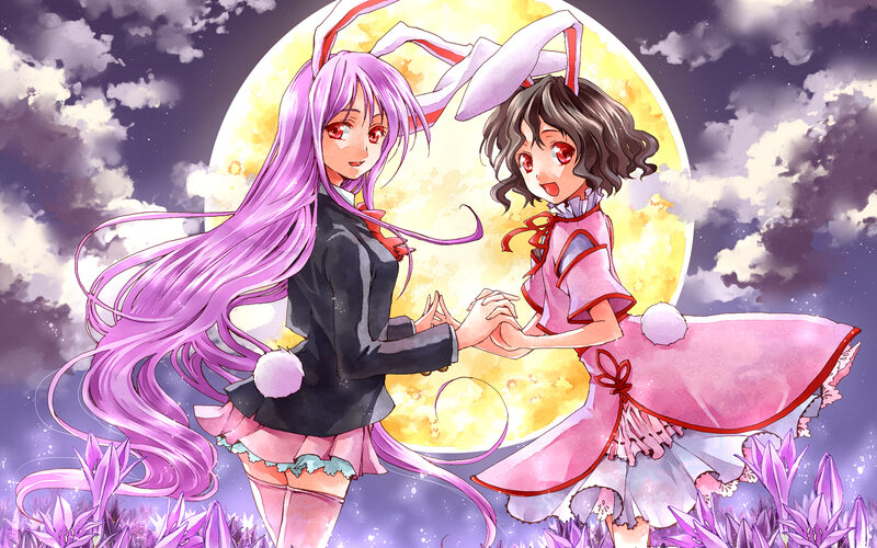 Two girls in bunny costumes under the moon