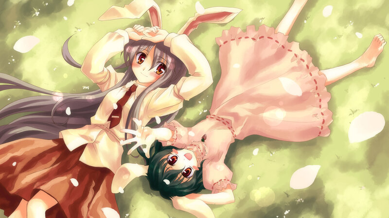 Two girls in bunny ears on grass