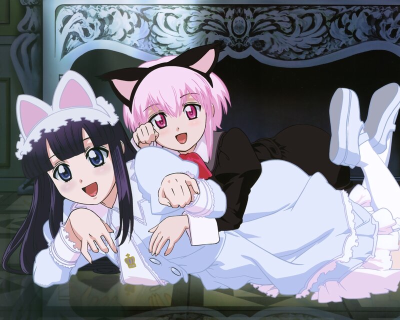 Two girls in cat ears on a couch