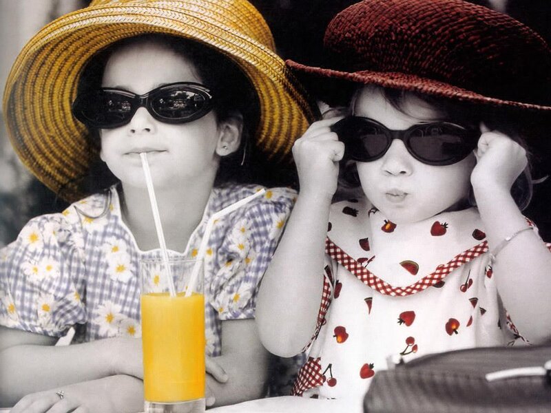 two girls in hats and sunglasses