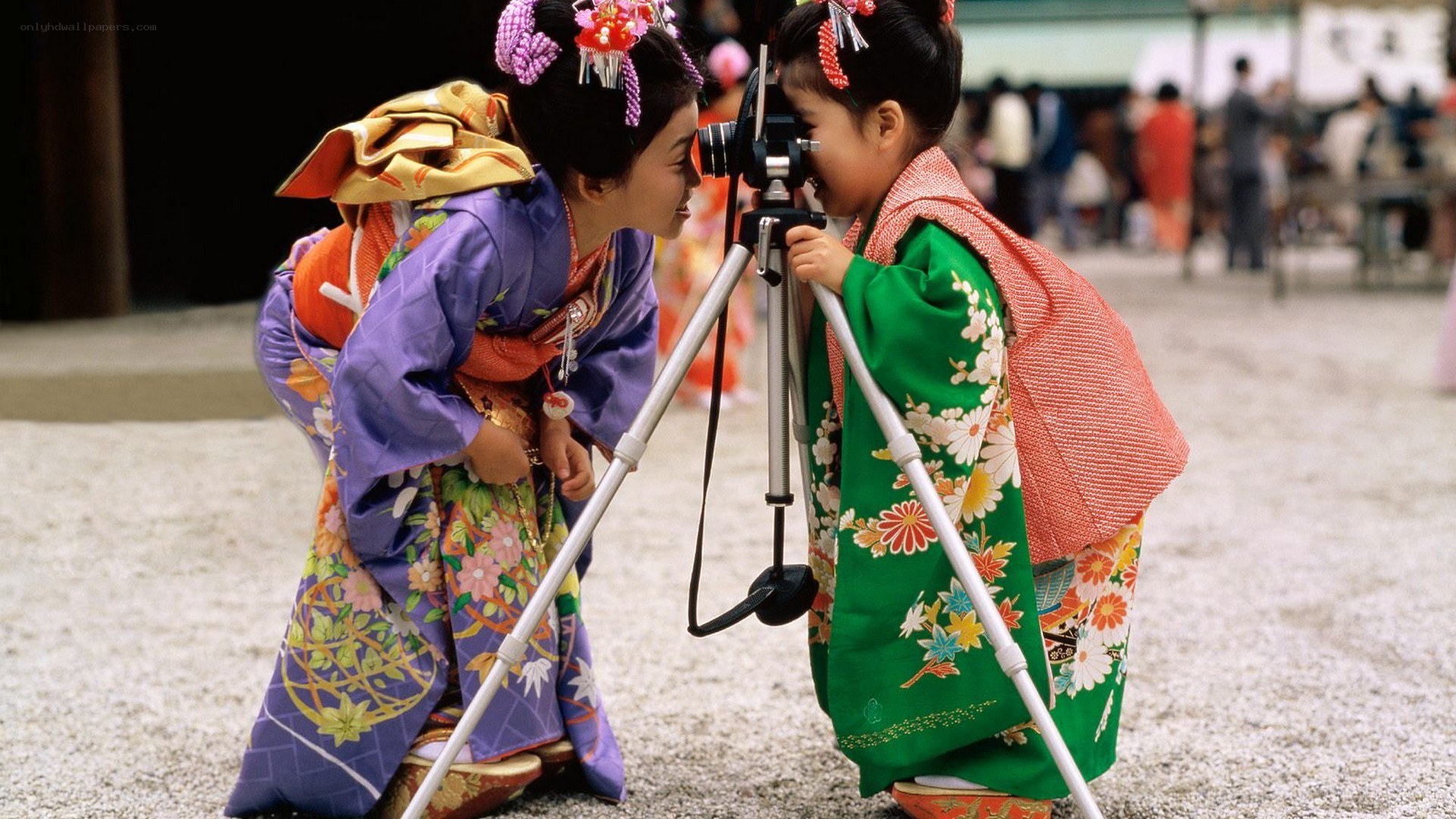 Two girls in kimonos with camera