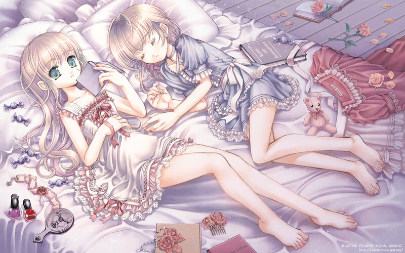 Two girls in nightgowns on a bed