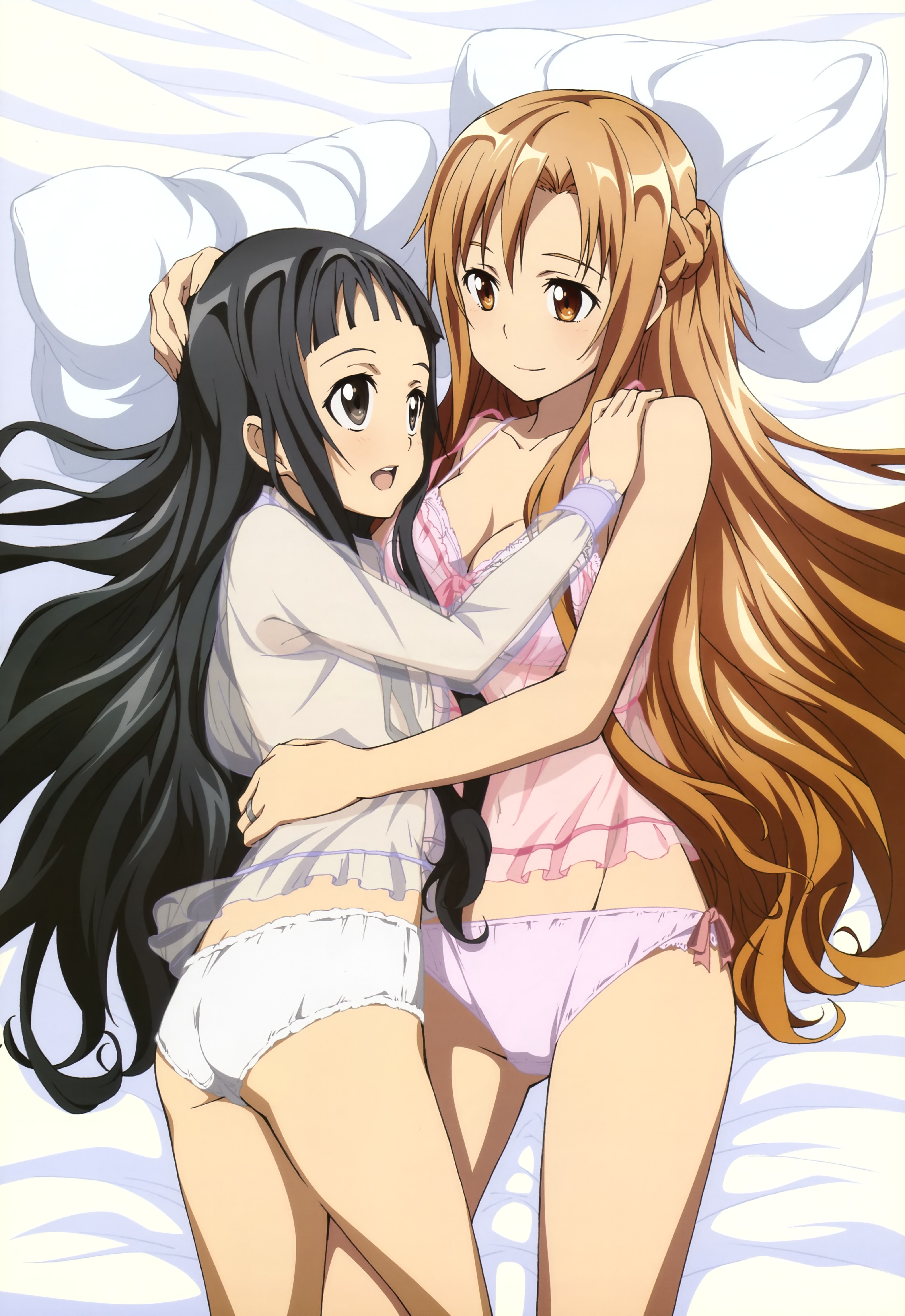 Two girls in pajamas hugging