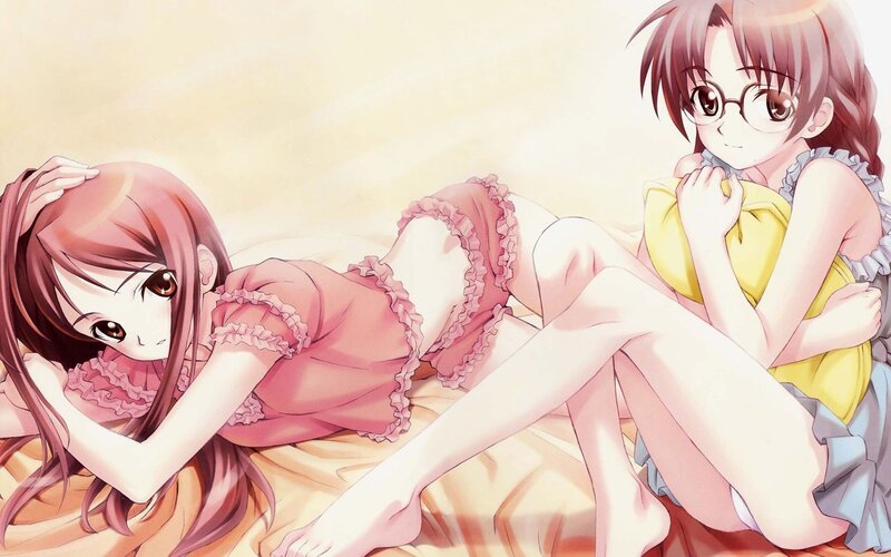 Two girls in pajamas on a bed