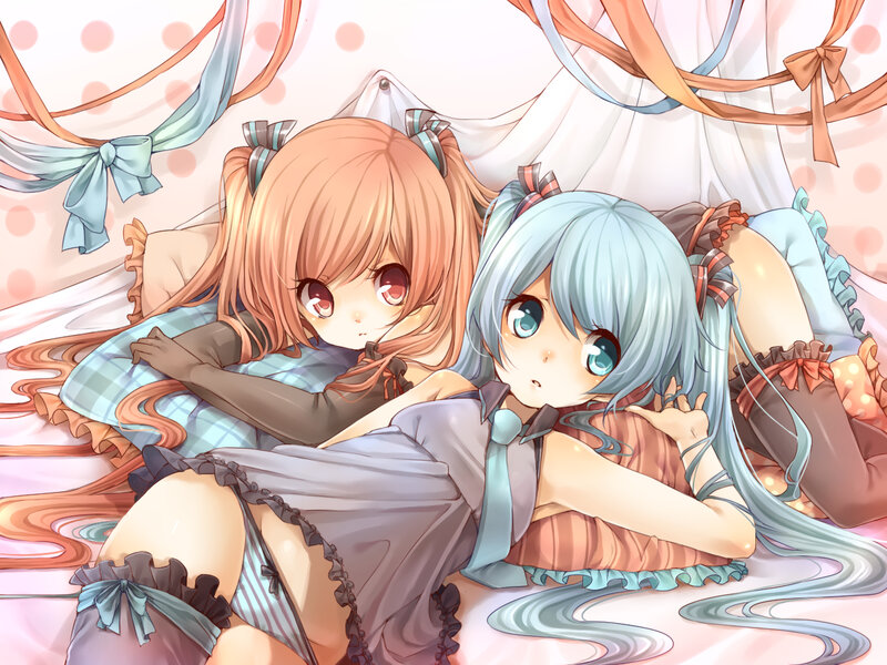 Two girls in pajamas on a bed