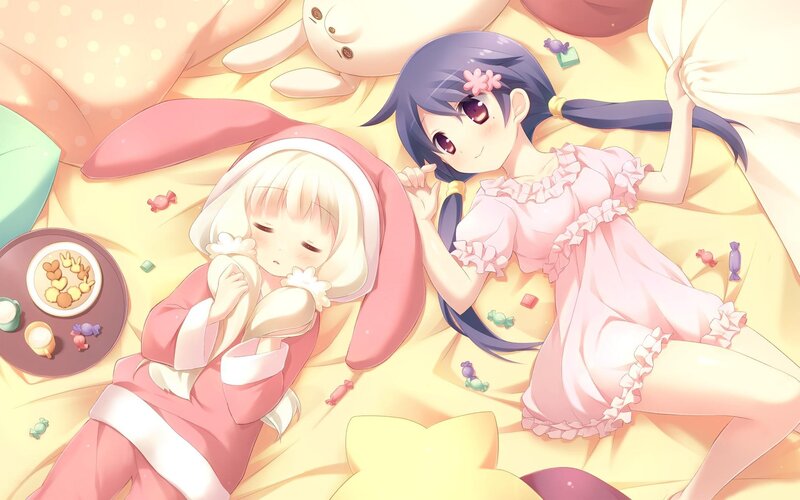 Two girls in pajamas on a bed