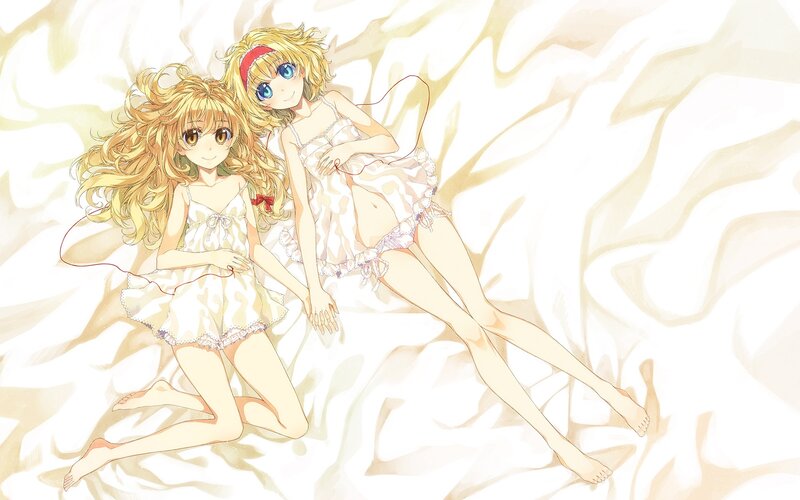Two girls in pajamas on a bed