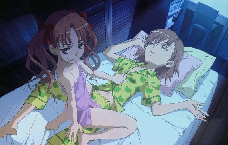 Two girls in pajamas on a bed