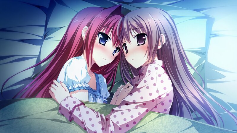 Two girls in pajamas on a bed