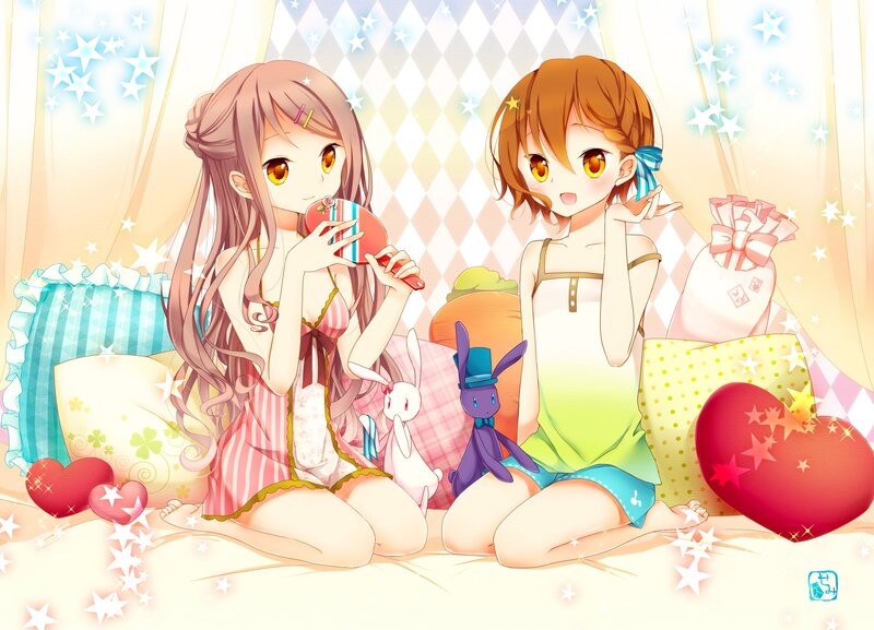 Two girls in pajamas on a bed