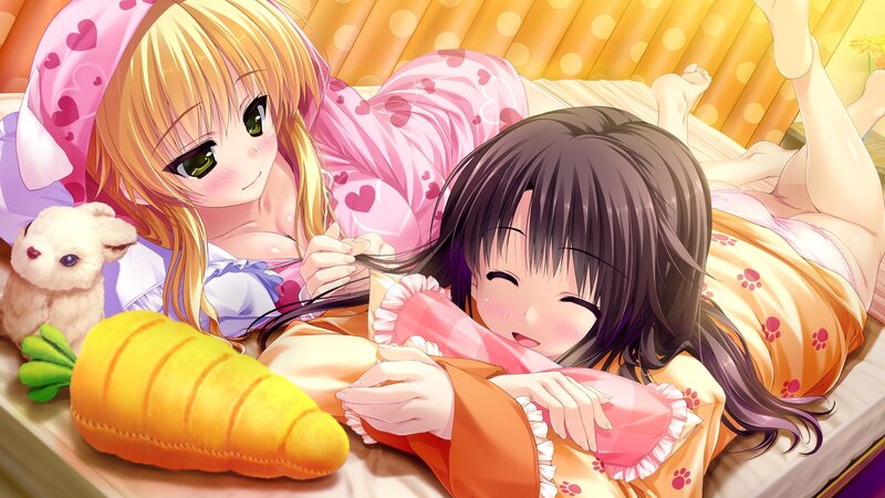 Two girls in pajamas on a bed