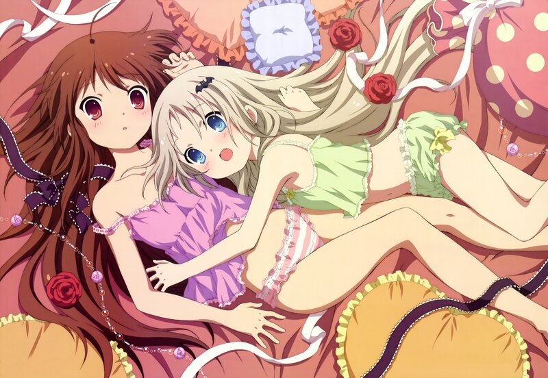 Two girls in pajamas on a bed