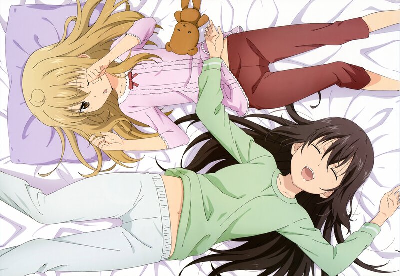 Two girls in pajamas on a bed