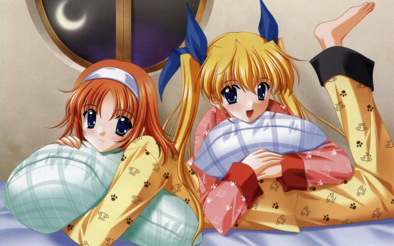 Two girls in pajamas on a bed