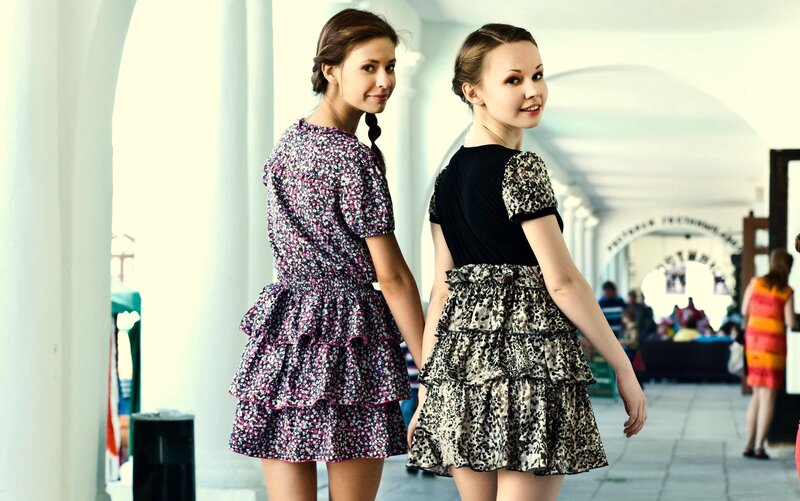 Two girls in patterned dresses