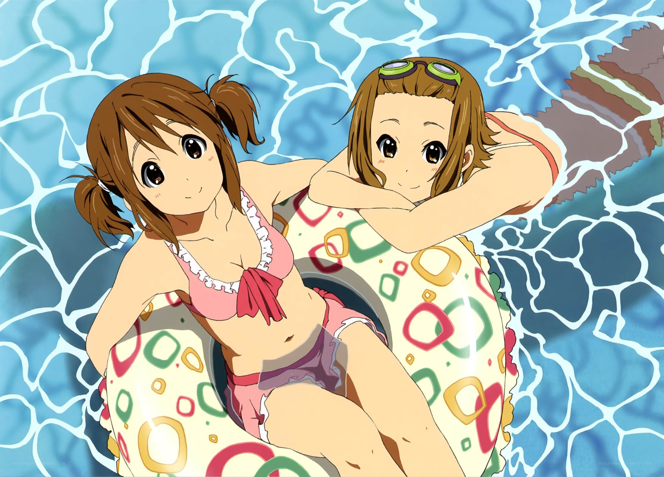 Two girls in pool float