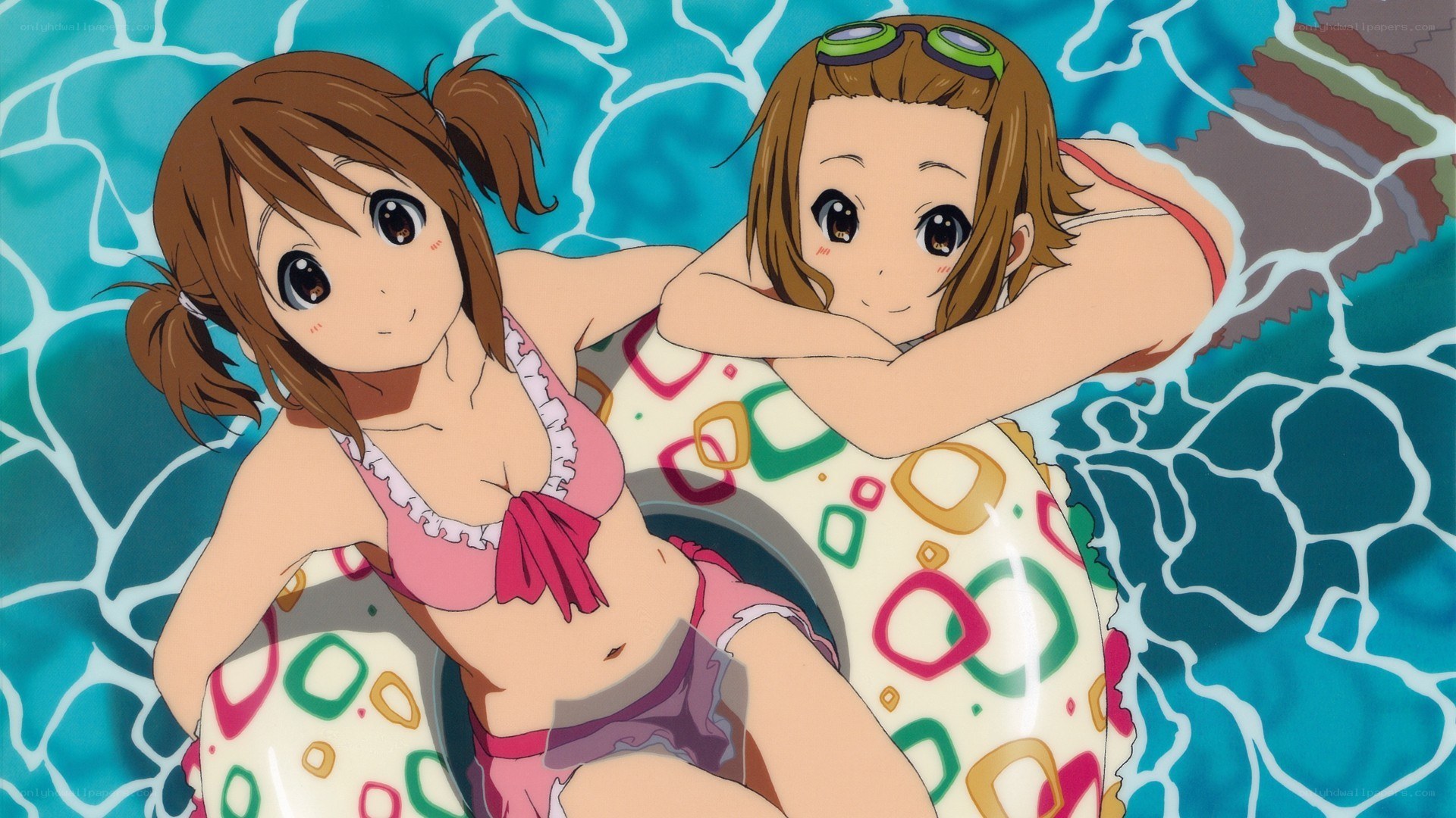 Two girls in pool floaties