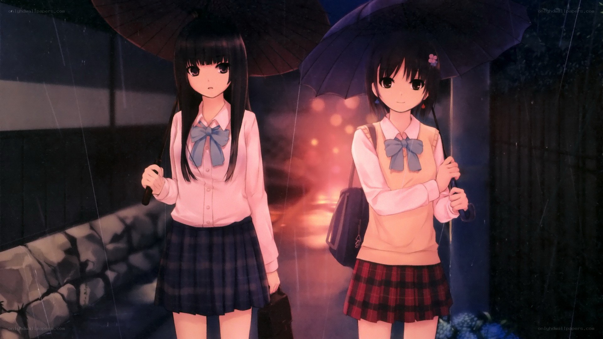 Two girls in rain with umbrellas