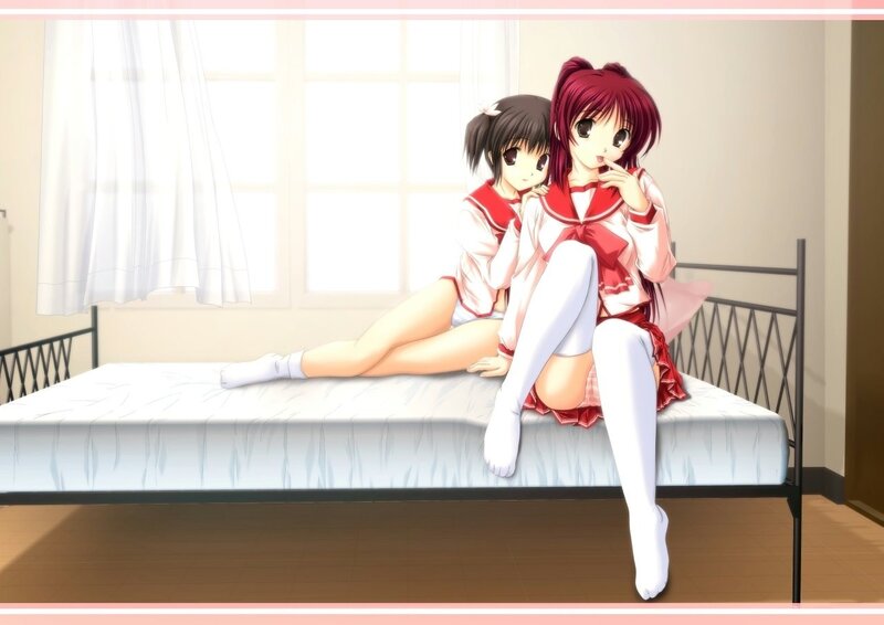 Two girls in school uniforms on a bed