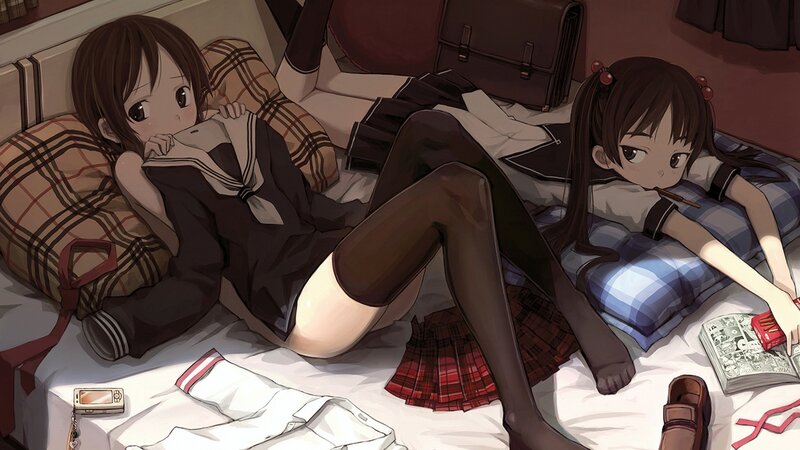Two girls in school uniforms on a bed
