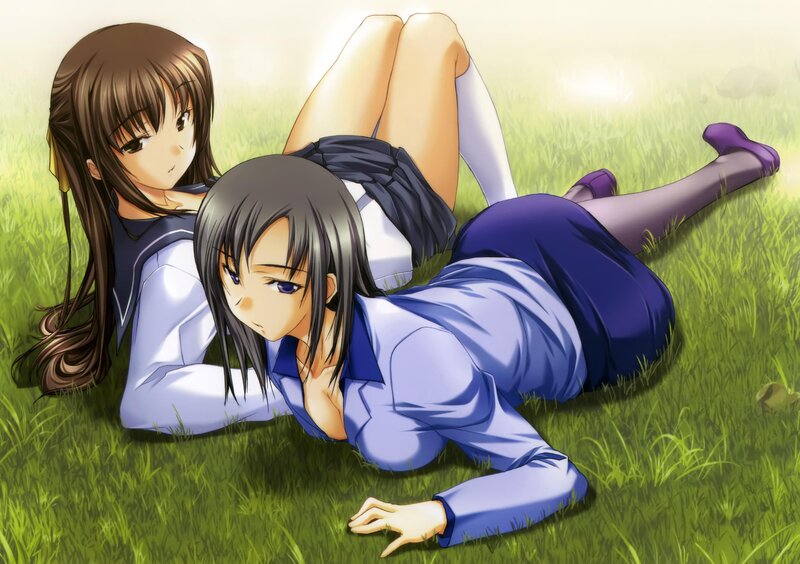 Two girls in school uniforms on grass