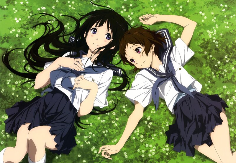 Two girls in school uniforms on grass