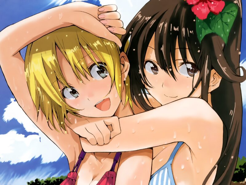 Two girls in swimsuits at the beach