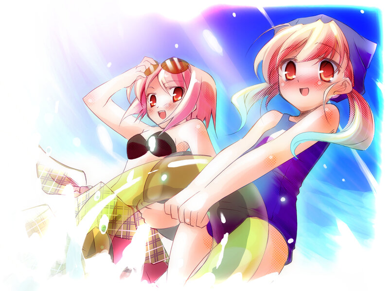 Two girls in swimsuits at the beach