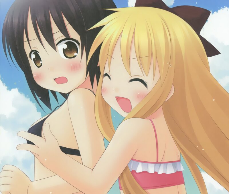 Two girls in swimsuits at the beach
