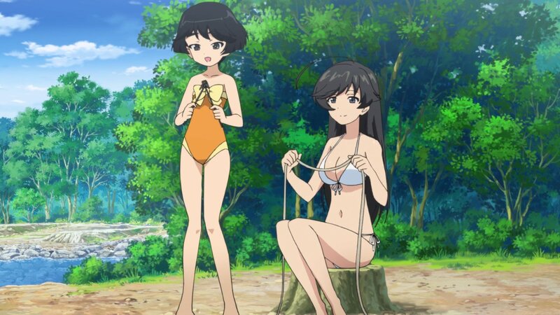 Two girls in swimsuits by a river