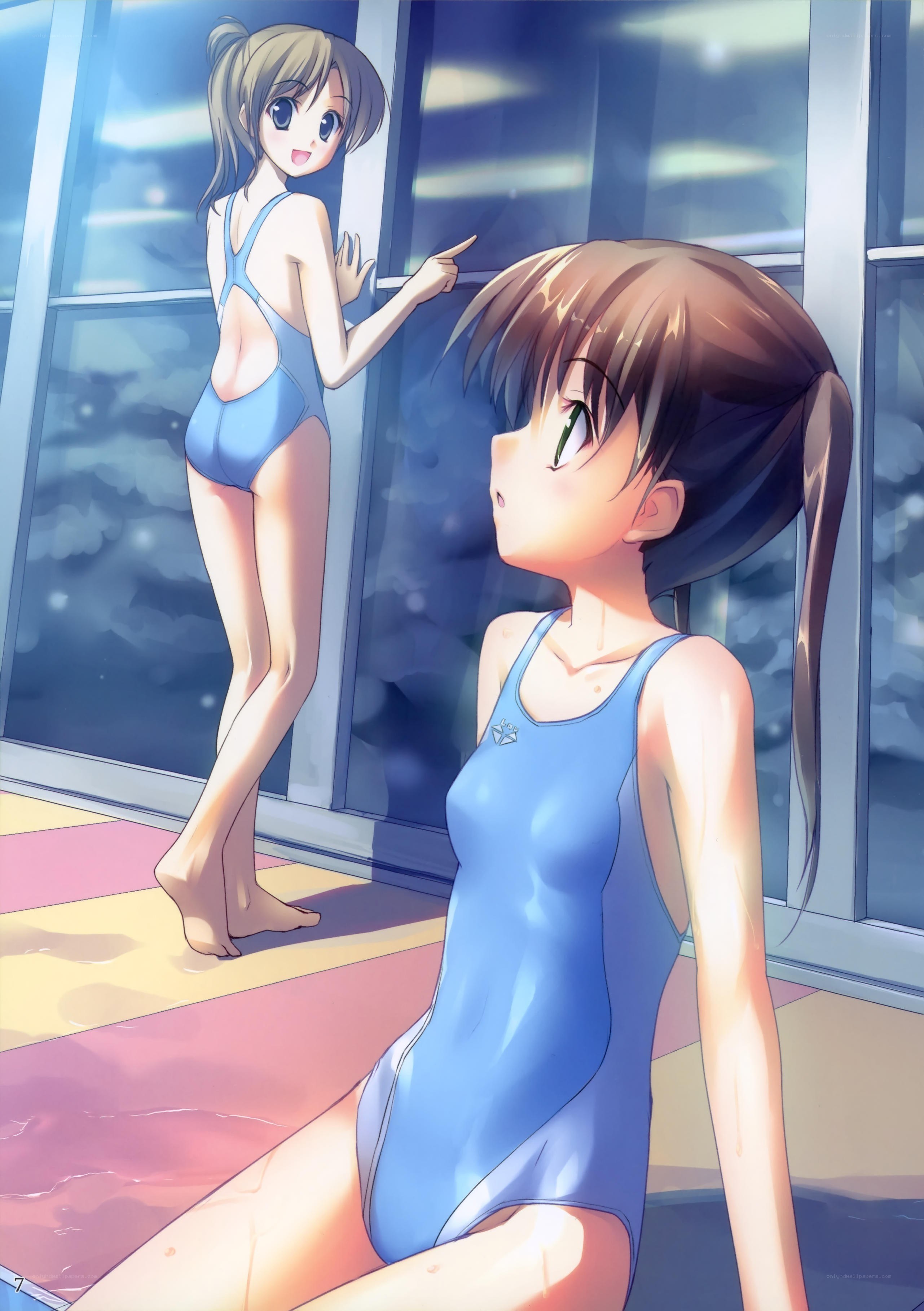 Two girls in swimsuits by pool