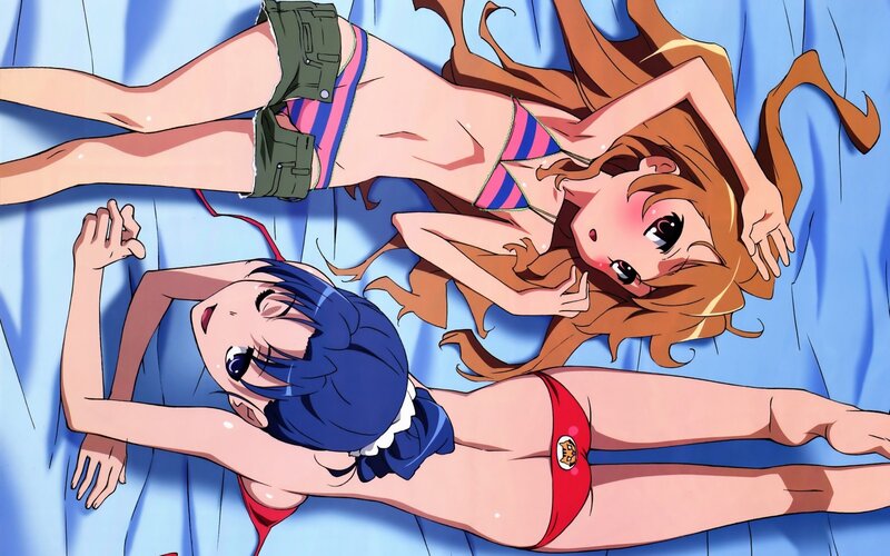 Two girls in swimsuits on a bed