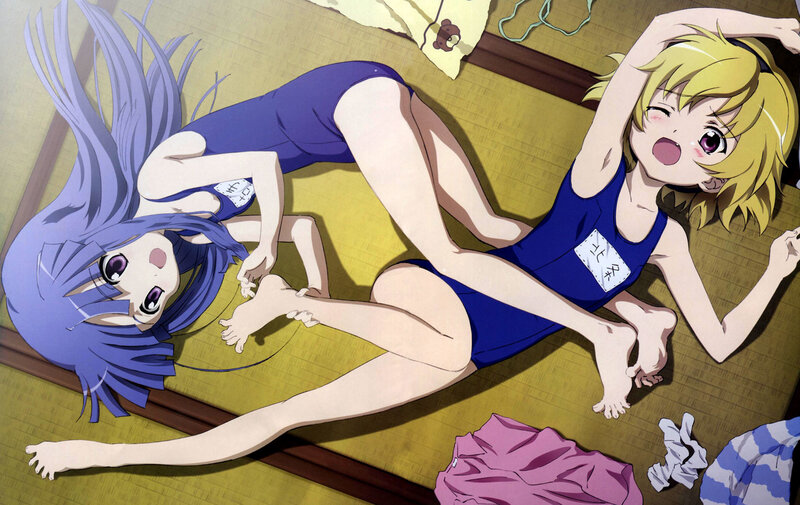 Two girls in swimsuits on a mat
