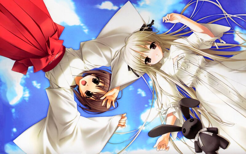 Two girls in white robes under blue sky