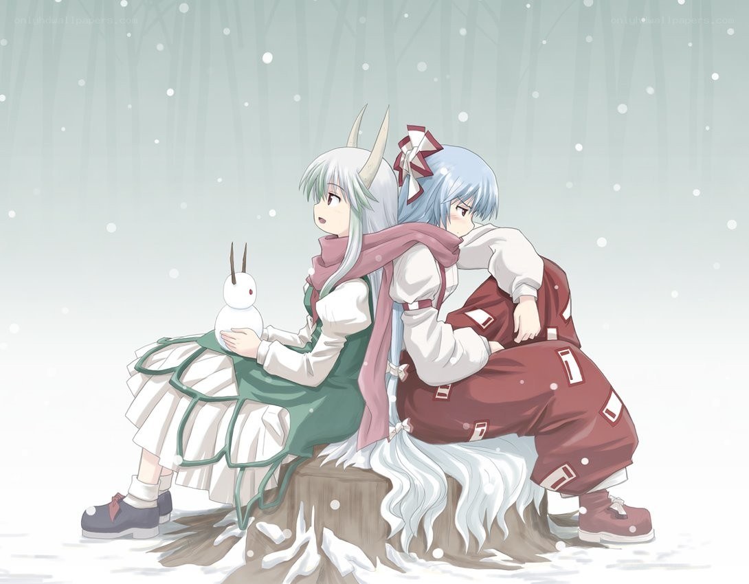 Two girls in winter with a snowman