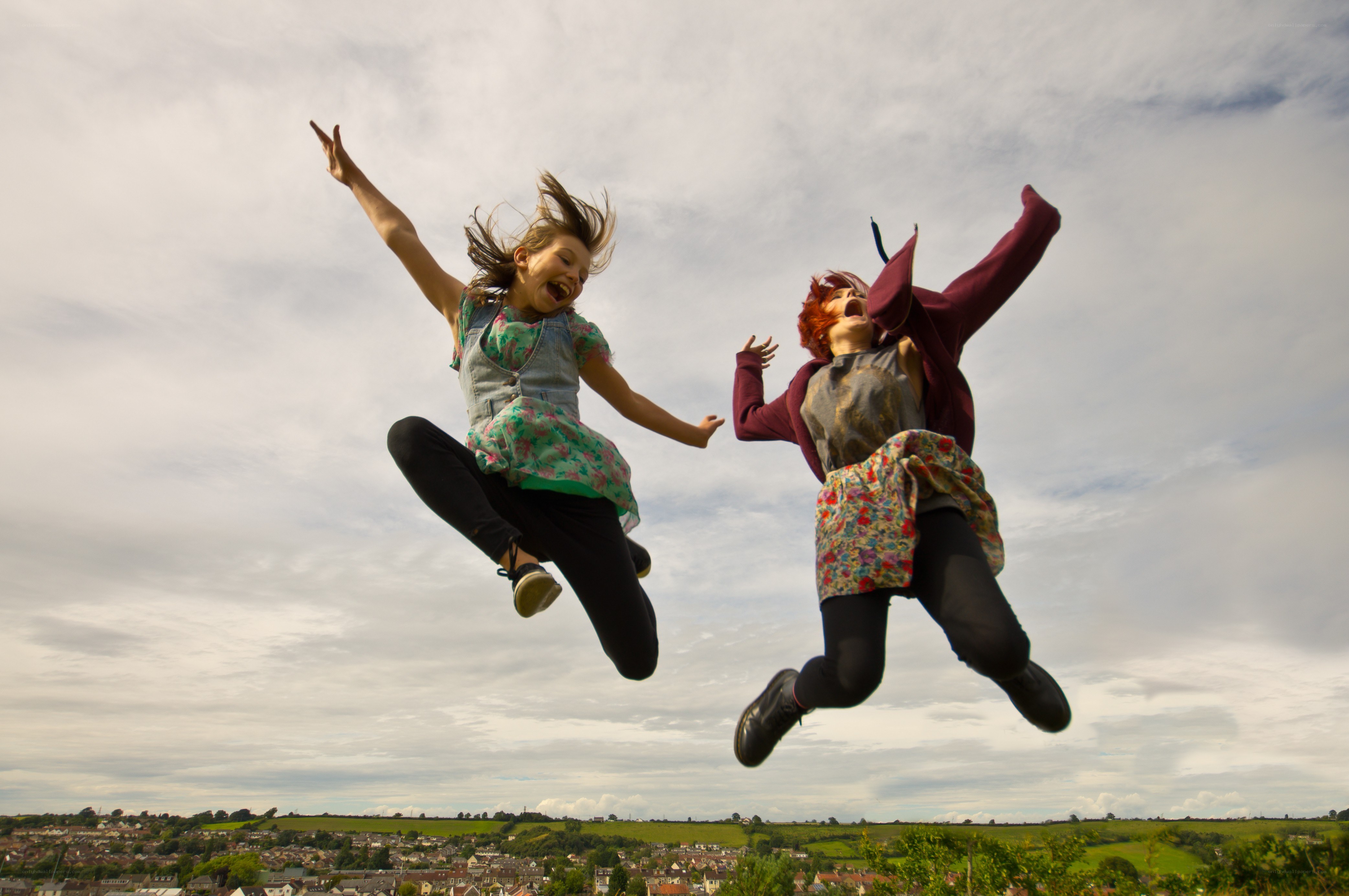 Two girls jumping in joy