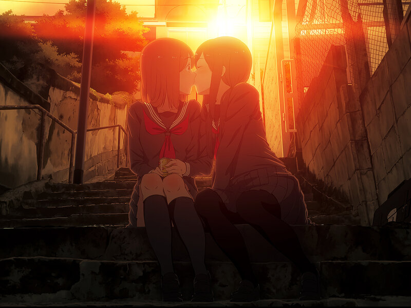 two girls kissing at sunset