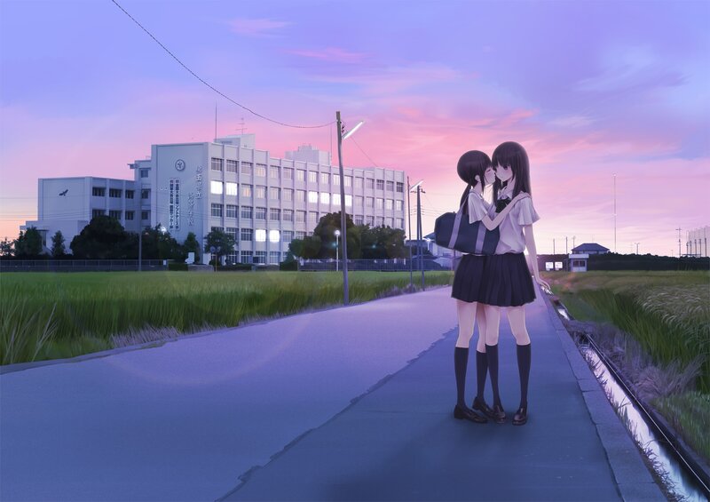 Two girls kissing at sunset