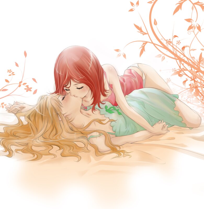 Two girls kissing in a field