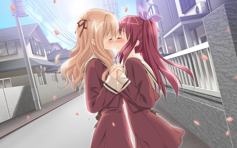 two girls kissing on a street